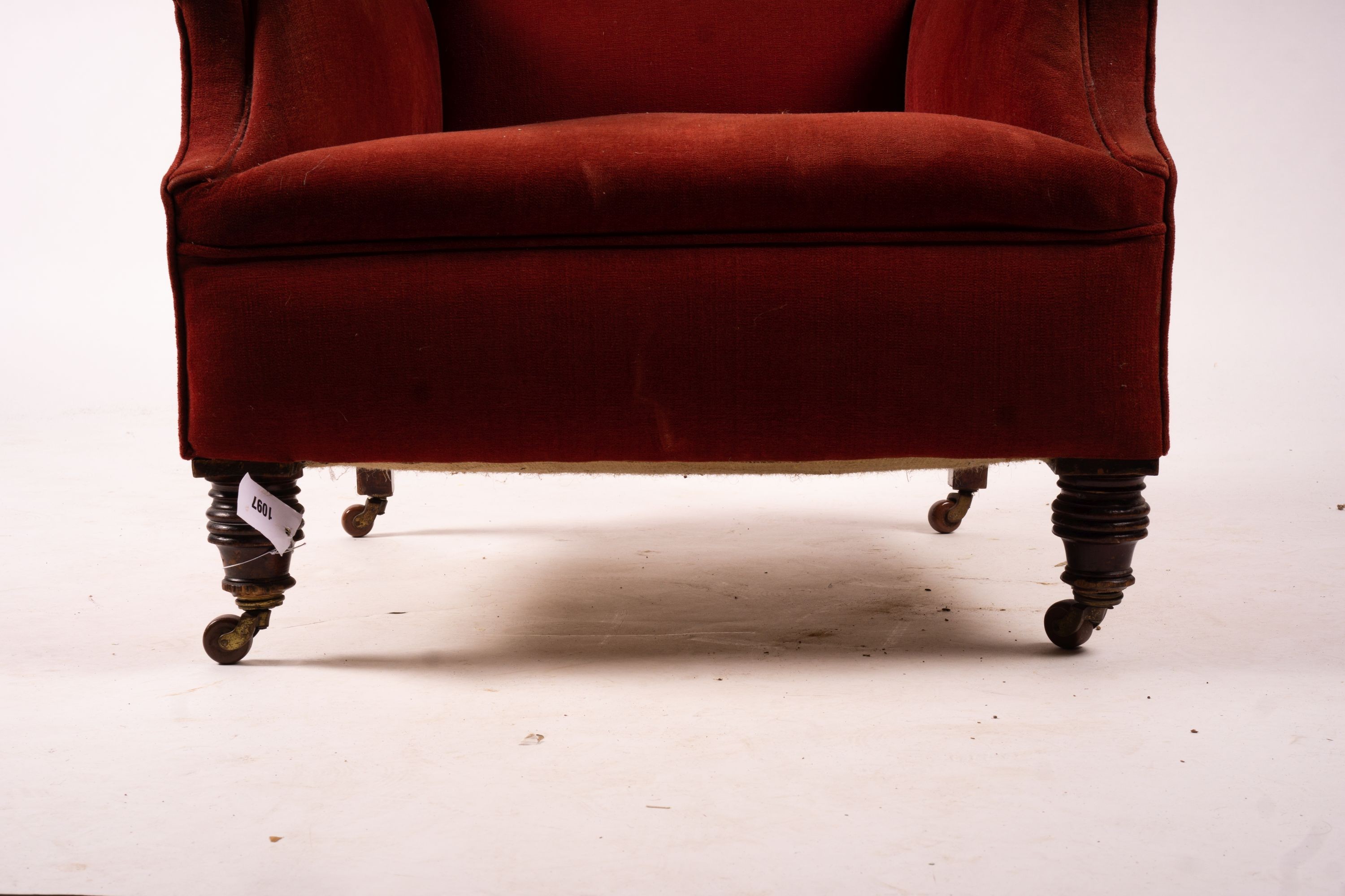 A late Victorian upholstered wing armchair, width 76cm, depth 70cm, height 100cm